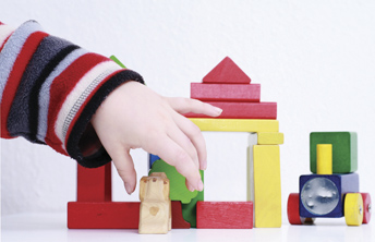 child playing with wooden blocks